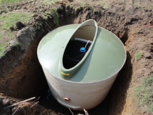 Sewage treatment plant sitting on concrete base ready for backfill