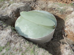 Sewage treatment plant with concrete backfill
