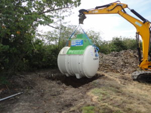 sewage treatment plant lowered into excavation