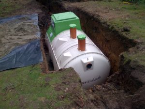 sewage treatment plant lowered on concrete base