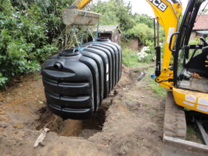 lowering septic tank into excavation
