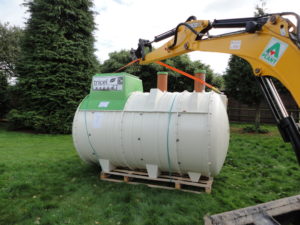 lifting sewage treatment plant with excavator for installation