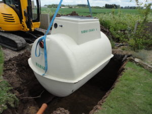 lowering sewage treatment plant into excavation