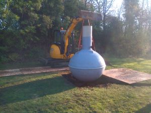 septic tank lowered into excavation
