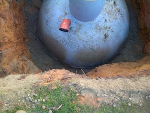 septic tank surrounded in concrete to anchor in place